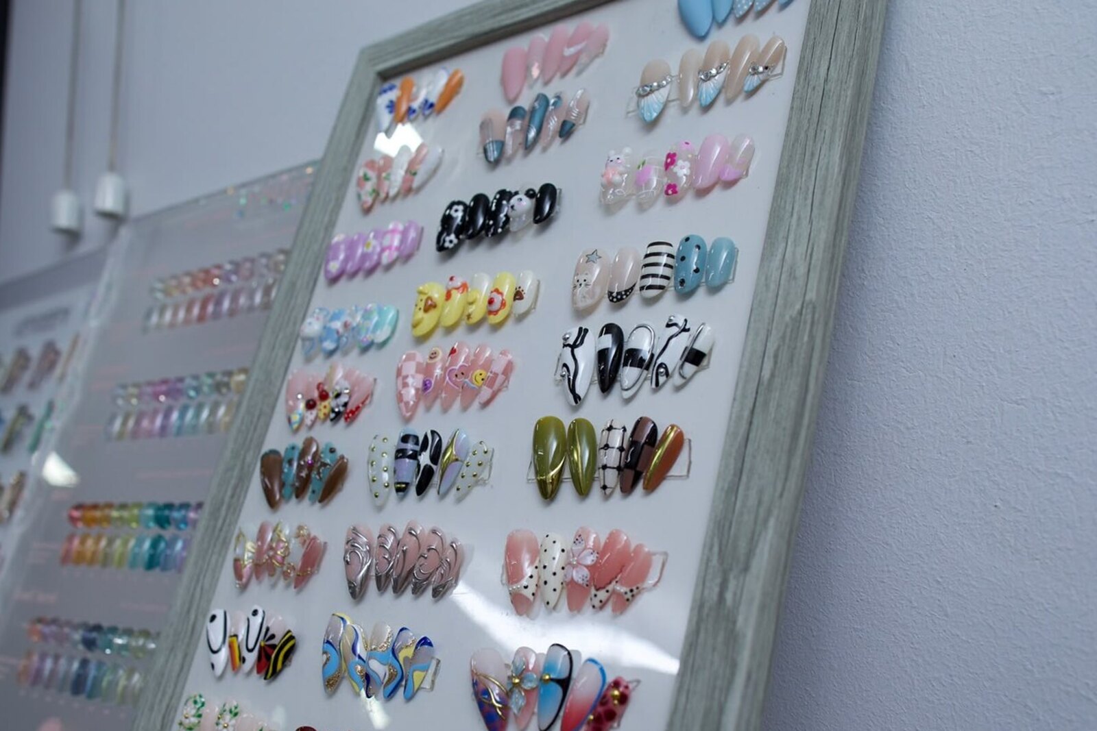 The wall of nail design sample boards inside Cathy Nail House